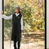 سارافون زنانه بلند تیره با فرم آزاد، ست شده با پیراهن سفید و بوت، برند مهین بانو